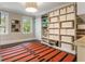 Versatile room with a built-in shelving unit offers plenty of storage, natural light, and a stylish accent rug at 808 Lullwater Ne Rd, Atlanta, GA 30307