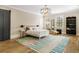 Spacious bedroom with modern light fixture, barn door access, and natural light at 808 Lullwater Ne Rd, Atlanta, GA 30307