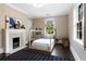 Charming bedroom features a playful house bed frame, marble fireplace, and a bright window at 808 Lullwater Ne Rd, Atlanta, GA 30307
