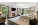 Bright primary bedroom featuring fireplace, mounted TV, balcony, and light hardwood flooring at 808 Lullwater Ne Rd, Atlanta, GA 30307