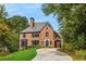 Brick exterior view of a two-story home with mature trees and a winding driveway at 808 Lullwater Ne Rd, Atlanta, GA 30307