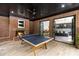 An indoor game room features a ping pong table, brick fireplace, and wet bar at 808 Lullwater Ne Rd, Atlanta, GA 30307
