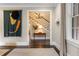 Hallway featuring hardwood floors, white trim, staircase, and decorative lighting at 808 Lullwater Ne Rd, Atlanta, GA 30307