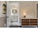 Hallway view leading to a bright bathroom, featuring a modern dresser and stylish decor at 808 Lullwater Ne Rd, Atlanta, GA 30307