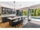 An elegant kitchen island with seating has doors opening onto the backyard and pool at 808 Lullwater Ne Rd, Atlanta, GA 30307