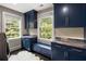 Functional laundry room features custom blue cabinetry, countertops, a sink, and a white rug at 808 Lullwater Ne Rd, Atlanta, GA 30307