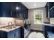 Laundry room with navy cabinets, modern washer and dryer and ample countertop space at 808 Lullwater Ne Rd, Atlanta, GA 30307