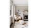 Cozy reading nook with a plush rocking chair, fireplace, and bright natural light streaming through the windows at 808 Lullwater Ne Rd, Atlanta, GA 30307