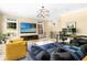 Open living room with contemporary chandelier, TV and large windows for plenty of natural light at 808 Lullwater Ne Rd, Atlanta, GA 30307