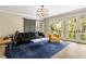 Bright living room with a sliding barn door, modern lighting and access to the outside at 808 Lullwater Ne Rd, Atlanta, GA 30307