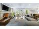 Bright living room with fireplace, french doors, hardwood floors, and adjacent bar at 808 Lullwater Ne Rd, Atlanta, GA 30307