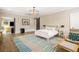 Open, airy bedroom with a modern light fixture, chair and sitting area at 808 Lullwater Ne Rd, Atlanta, GA 30307