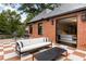 Relax on the outdoor patio with a checkerboard tile floor and a seamless transition to the primary bedroom at 808 Lullwater Ne Rd, Atlanta, GA 30307