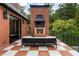 Stylish outdoor patio with brick fireplace, checkered tile flooring, and comfortable seating at 808 Lullwater Ne Rd, Atlanta, GA 30307