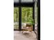 An enclosed patio has a wooden chair and offers scenic backyard views at 808 Lullwater Ne Rd, Atlanta, GA 30307