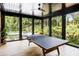 An enclosed patio has a ping pong table and offers scenic backyard views at 808 Lullwater Ne Rd, Atlanta, GA 30307