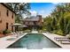A luxurious in-ground pool with lounge chairs sits between the main house and the guest house at 808 Lullwater Ne Rd, Atlanta, GA 30307