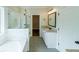 Modern bathroom with a glass enclosed shower, separate tub, and granite countertop at 82 Lexie Court, Rockmart, GA 30153