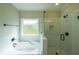 Bathroom featuring a soaking tub and a glass enclosed shower at 82 Lexie Court, Rockmart, GA 30153