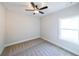A cozy bedroom features a ceiling fan, window and neutral carpet, creating a tranquil atmosphere at 82 Lexie Court, Rockmart, GA 30153