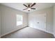 Cozy bedroom with a ceiling fan, window, plush carpet, and double door closet for ample storage at 82 Lexie Court, Rockmart, GA 30153
