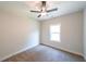 Inviting bedroom with a ceiling fan, soft carpet, and natural light from the window at 82 Lexie Court, Rockmart, GA 30153