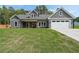 Charming craftsman-style home with gray siding, a manicured lawn, and an attached two-car garage at 82 Lexie Court, Rockmart, GA 30153