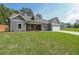 Charming craftsman-style home with gray siding, a manicured lawn, and an attached two-car garage at 82 Lexie Court, Rockmart, GA 30153