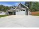 Craftsman-style home featuring an attached two-car garage and concrete driveway with ample parking at 82 Lexie Court, Rockmart, GA 30153