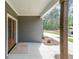 Covered front porch featuring craftsman-style wood columns and a stained wood front door at 82 Lexie Court, Rockmart, GA 30153