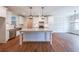 Modern kitchen features white cabinets, stainless steel appliances, granite countertops, and a center island at 82 Lexie Court, Rockmart, GA 30153