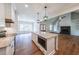 Contemporary kitchen featuring an island with a built-in microwave and granite countertops at 82 Lexie Court, Rockmart, GA 30153
