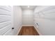 Bright laundry room with wood-look flooring and wire shelving perfect for organizing laundry supplies at 82 Lexie Court, Rockmart, GA 30153