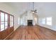 Open living room with vaulted ceiling, hardwood floors, fireplace, and built-in shelving at 82 Lexie Court, Rockmart, GA 30153