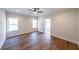 Spacious main bedroom featuring hardwood floors, a ceiling fan, and a view to the attached bath at 82 Lexie Court, Rockmart, GA 30153