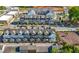 Drone shot of colorful townhomes, street parking, and a central green space at 118 Brighton Blvd, Woodstock, GA 30188