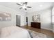 The bedroom features hardwood floors, a ceiling fan, and modern decor at 118 Brighton Blvd, Woodstock, GA 30188