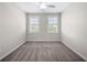 Neutral bedroom features plush carpet, ceiling fan, and abundant natural light at 118 Brighton Blvd, Woodstock, GA 30188