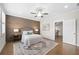 Bedroom boasts a wood accent wall, ceiling fan, and decorative rug at 118 Brighton Blvd, Woodstock, GA 30188