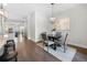 Cozy dining room with modern lighting fixture and view of adjacent living area at 118 Brighton Blvd, Woodstock, GA 30188