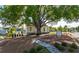 Community entrance featuring lush landscaping, a stone pathway, and mature shade trees at 118 Brighton Blvd, Woodstock, GA 30188