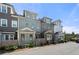 View of row of newly-constructed townhomes with varied colors and architectural styles at 118 Brighton Blvd, Woodstock, GA 30188