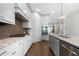 Gourmet kitchen with stainless appliances, granite counters, and custom cabinetry at 118 Brighton Blvd, Woodstock, GA 30188