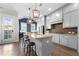 Stylish kitchen with granite counters, island seating, and open to a bright living space at 118 Brighton Blvd, Woodstock, GA 30188