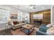 Bright living room featuring hardwood floors, an accent wall, a fireplace, and comfortable seating at 118 Brighton Blvd, Woodstock, GA 30188