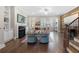 Cozy living room featuring hardwood floors, fireplace, built-in shelves and large windows at 118 Brighton Blvd, Woodstock, GA 30188