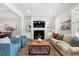 Bright living room featuring a fireplace, built-in shelves, hardwood floors, and comfortable seating at 118 Brighton Blvd, Woodstock, GA 30188