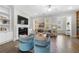 Inviting living room featuring a fireplace, built-in shelves, hardwood floors, and comfortable seating at 118 Brighton Blvd, Woodstock, GA 30188