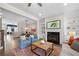 Open living room featuring a fireplace, hardwood floors, and open access to the dining area and kitchen at 118 Brighton Blvd, Woodstock, GA 30188