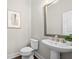 Stylish powder room featuring a pedestal sink, modern fixtures, and a framed art print at 118 Brighton Blvd, Woodstock, GA 30188